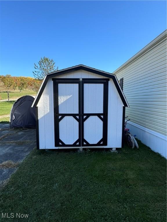 view of outbuilding with a lawn