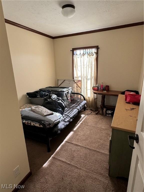 bedroom with a textured ceiling and carpet floors