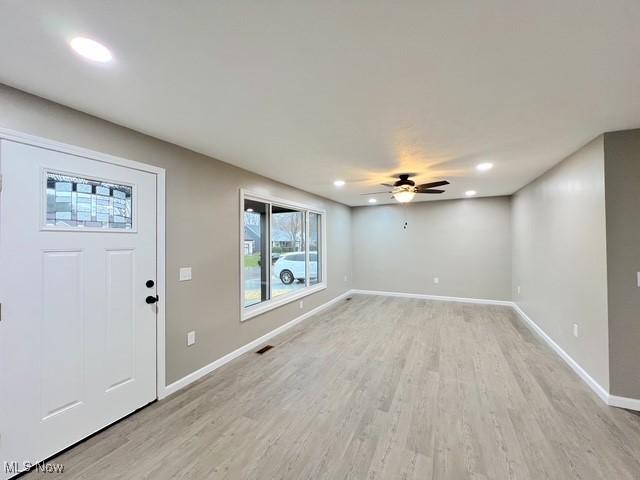 foyer with light hardwood / wood-style flooring and ceiling fan