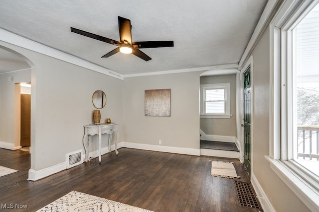 unfurnished room with a textured ceiling, dark hardwood / wood-style flooring, and ceiling fan