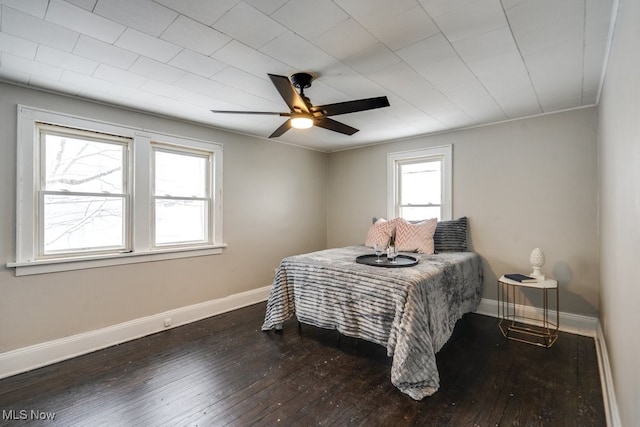 bedroom with ceiling fan and dark wood-type flooring