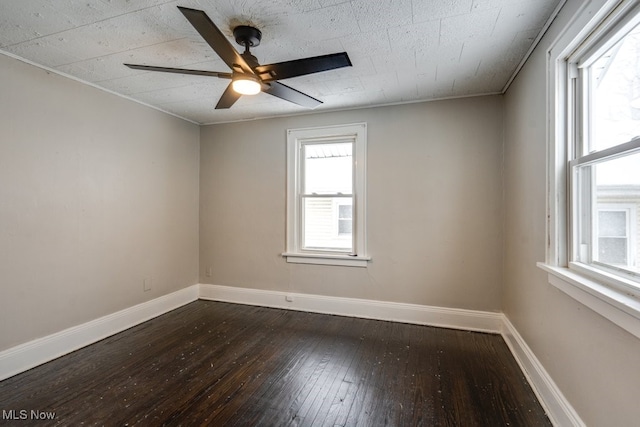 spare room featuring dark hardwood / wood-style flooring and ceiling fan