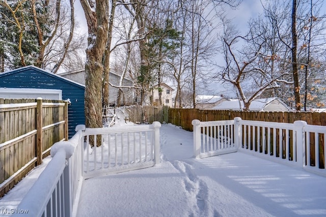 yard layered in snow with a deck