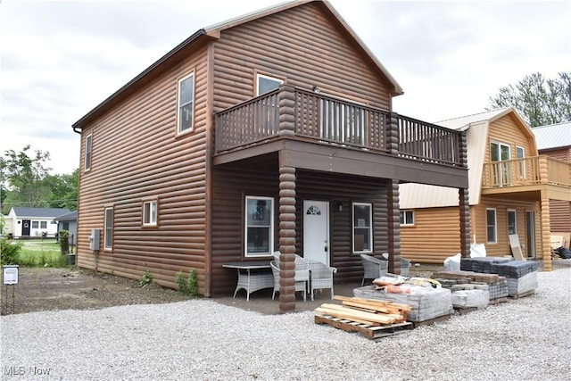 back of property with a balcony