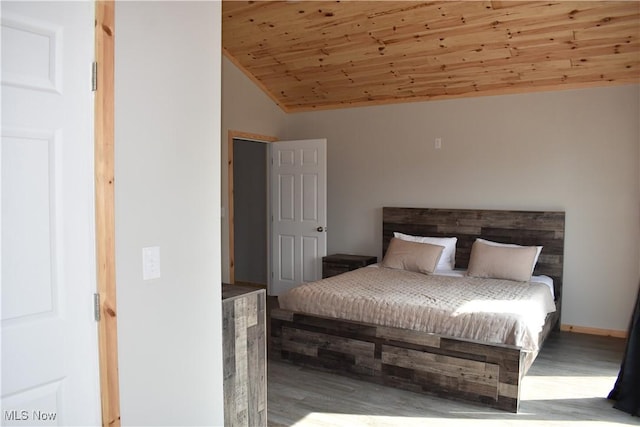 bedroom with wood ceiling, wood finished floors, and lofted ceiling