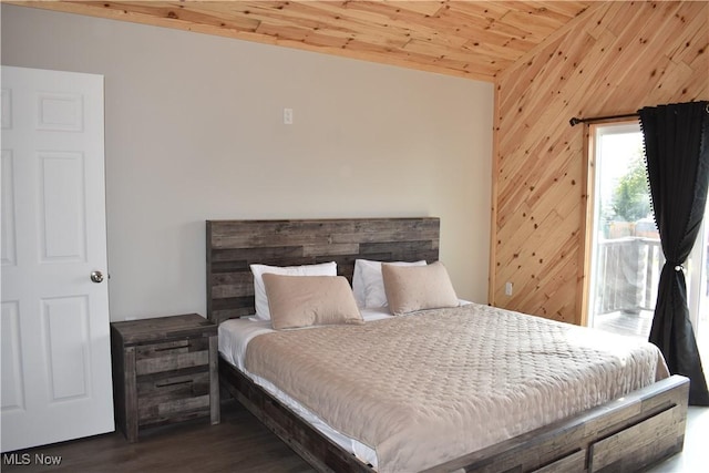 bedroom featuring wooden walls, dark hardwood / wood-style flooring, wood ceiling, and vaulted ceiling