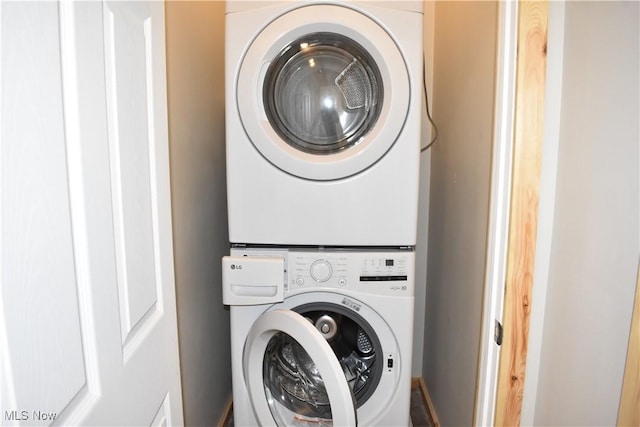 washroom with stacked washer and clothes dryer