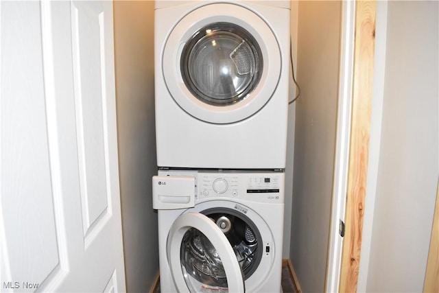 washroom featuring stacked washing maching and dryer and laundry area