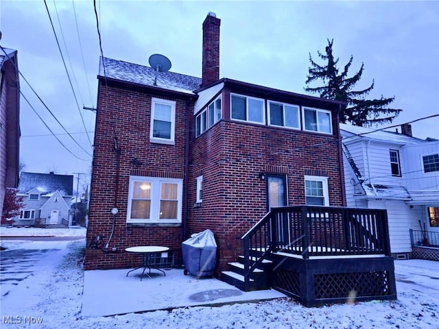 view of snow covered rear of property