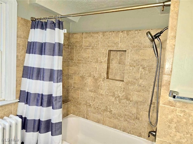 bathroom featuring shower / bath combo with shower curtain and radiator