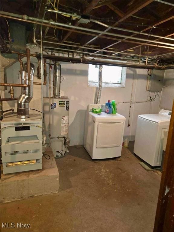 basement with washing machine and dryer and water heater