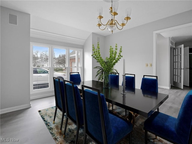 dining space with vaulted ceiling and a notable chandelier