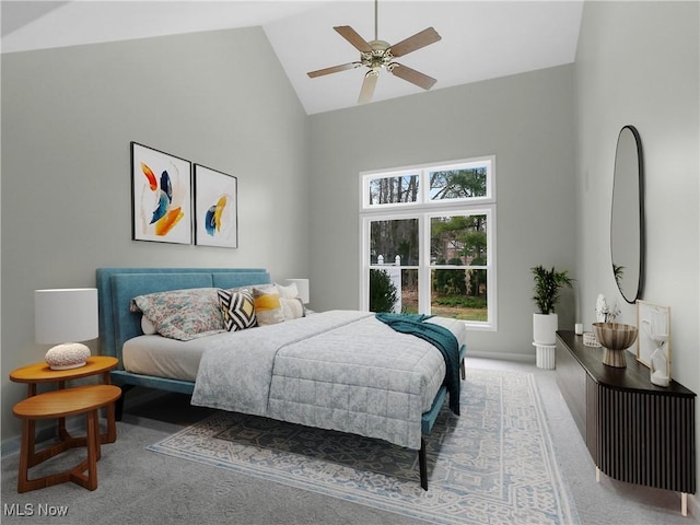 carpeted bedroom featuring ceiling fan and high vaulted ceiling