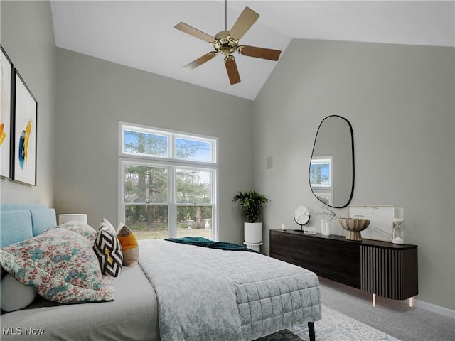 carpeted bedroom with high vaulted ceiling and ceiling fan