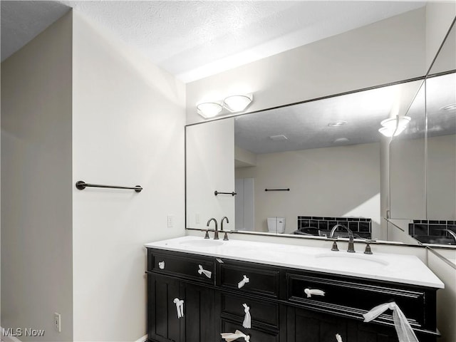 bathroom with vanity and a textured ceiling