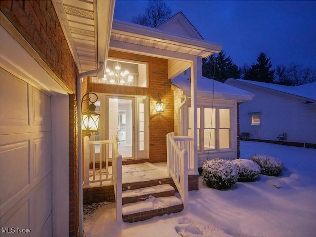 view of snow covered property entrance