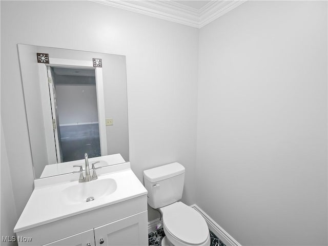 bathroom with vanity, toilet, and crown molding