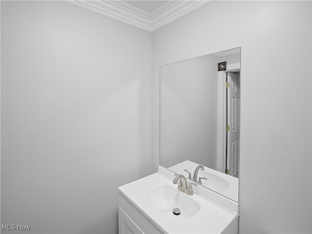 bathroom with vanity and ornamental molding