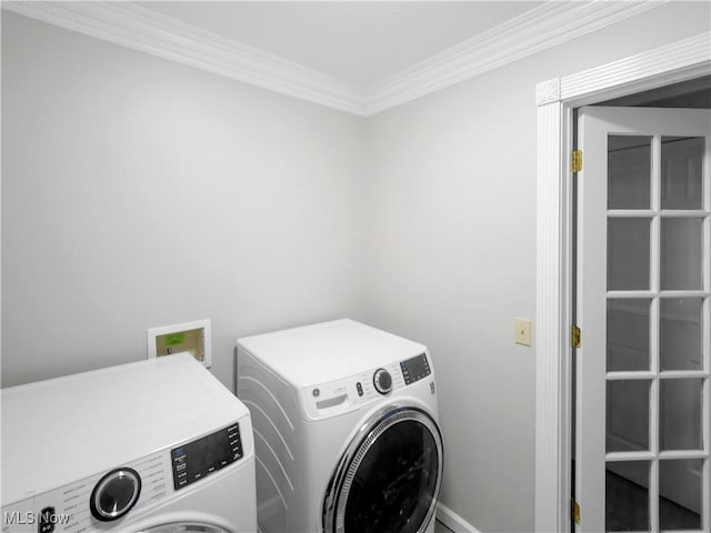 laundry room featuring washer and clothes dryer and ornamental molding