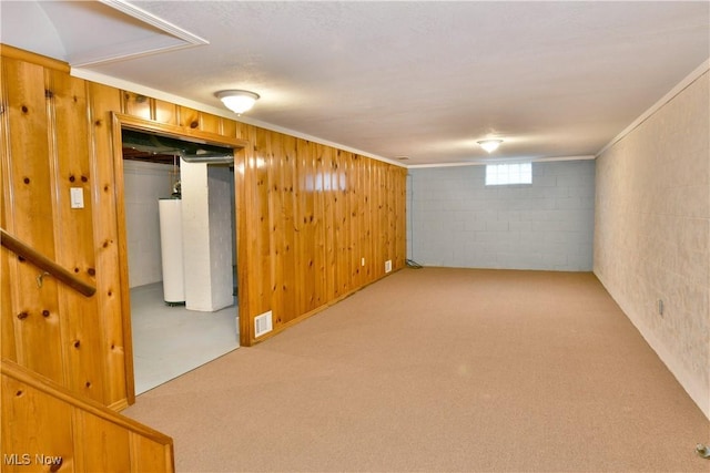 basement with water heater, wooden walls, and carpet