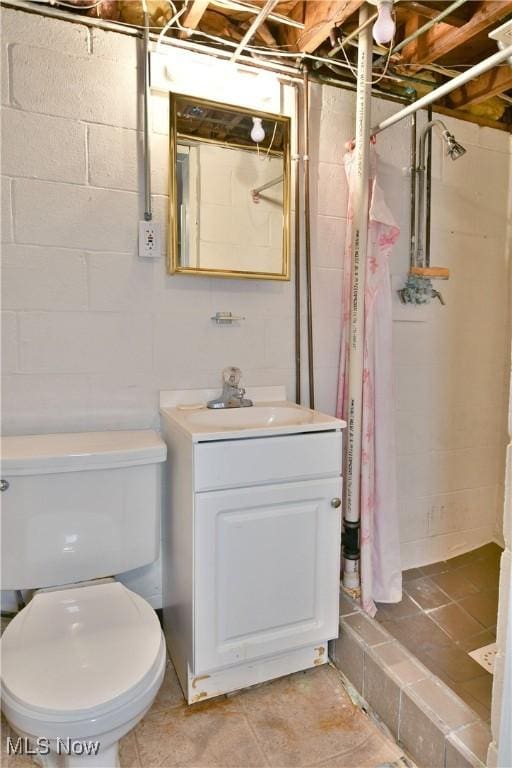 bathroom featuring vanity, toilet, and walk in shower