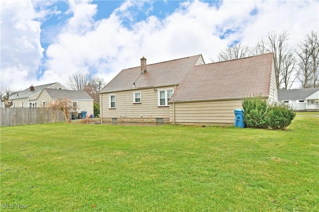 rear view of property with a lawn