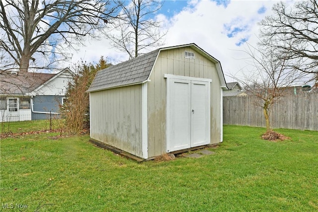 view of outbuilding with a yard