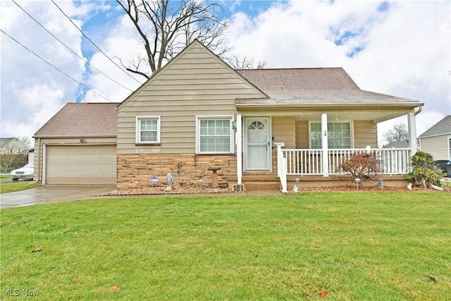 view of front of home with a front lawn, covered porch, and a garage