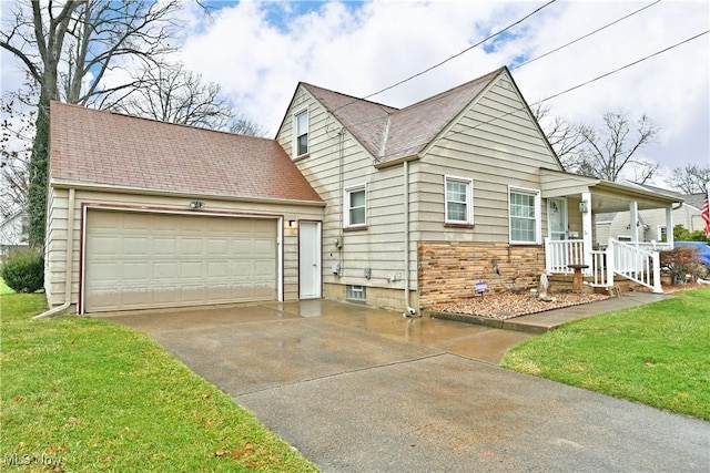 view of front facade featuring a front yard, a porch, and a garage