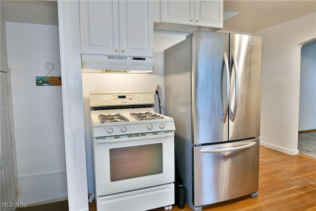 kitchen with white cabinetry, stainless steel refrigerator, white range with gas cooktop, and light hardwood / wood-style flooring