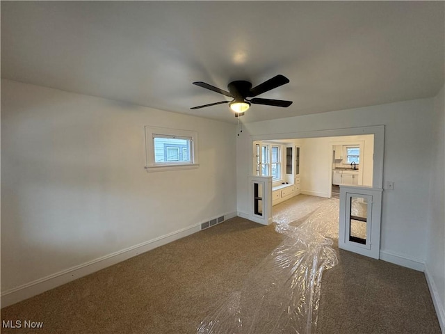 unfurnished room featuring carpet floors and ceiling fan