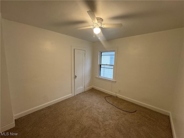 spare room with carpet and ceiling fan