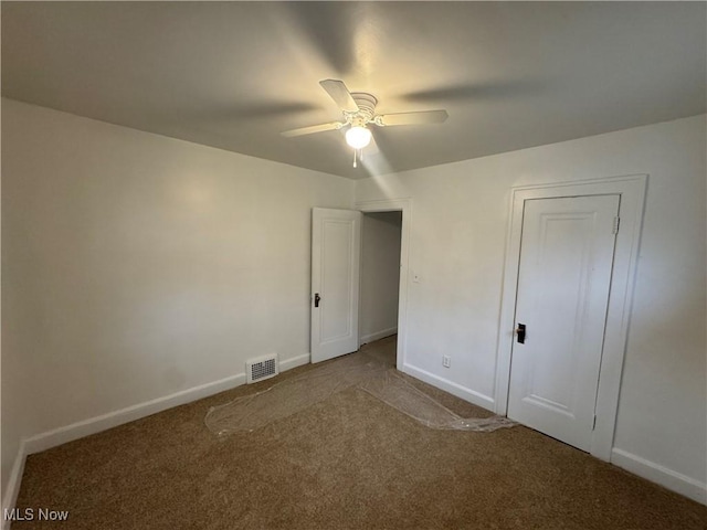 unfurnished bedroom featuring carpet flooring and ceiling fan