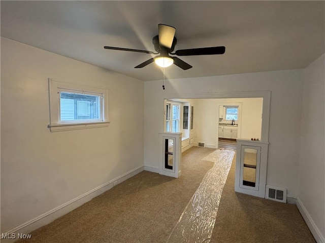 unfurnished room featuring carpet flooring and ceiling fan