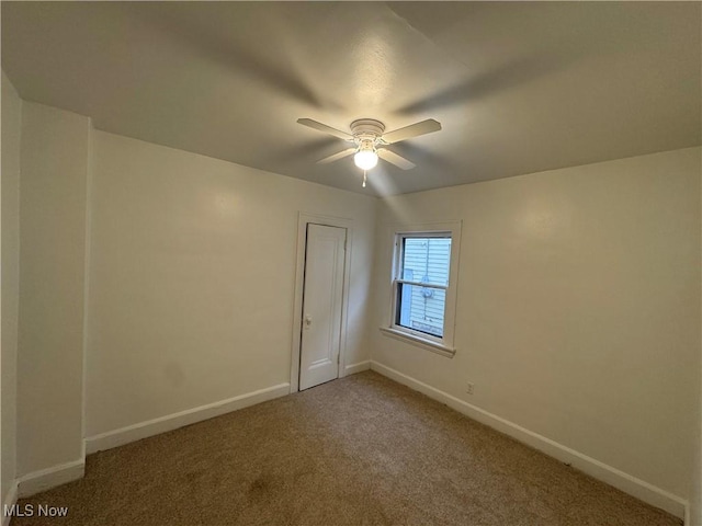 carpeted empty room with ceiling fan