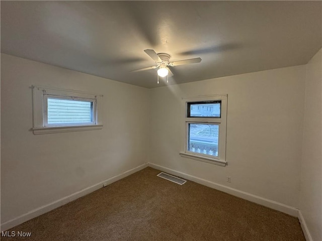 empty room featuring carpet flooring and ceiling fan