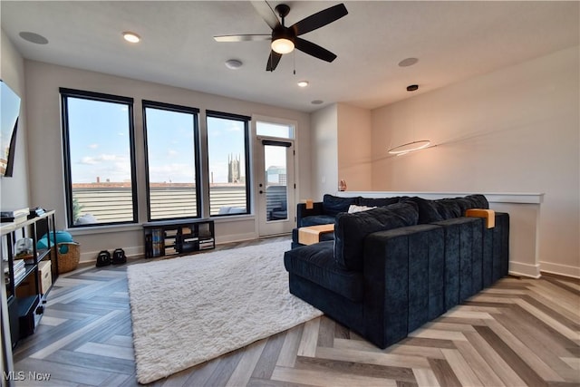 living room with recessed lighting, a ceiling fan, and baseboards