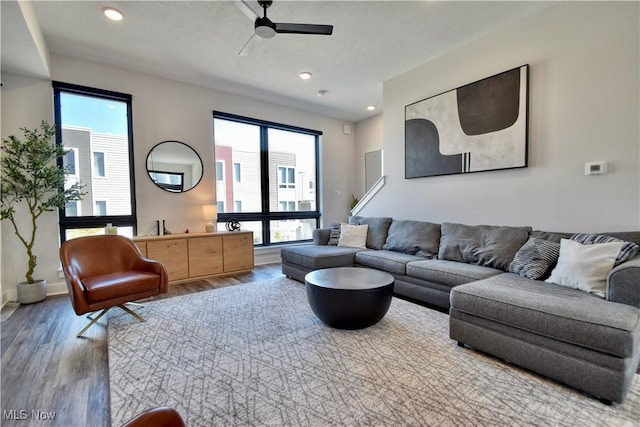 living area featuring baseboards, wood finished floors, recessed lighting, and ceiling fan
