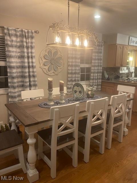 dining room with hardwood / wood-style flooring and sink