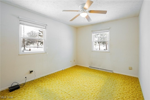 empty room with carpet flooring, ceiling fan, a textured ceiling, and a baseboard heating unit