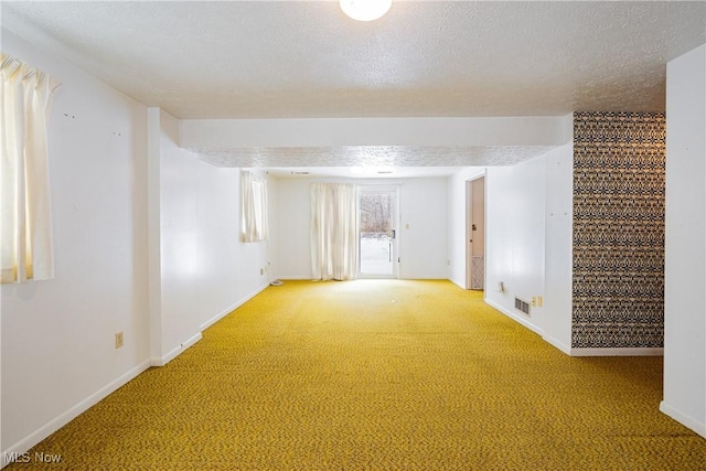 carpeted spare room featuring a textured ceiling