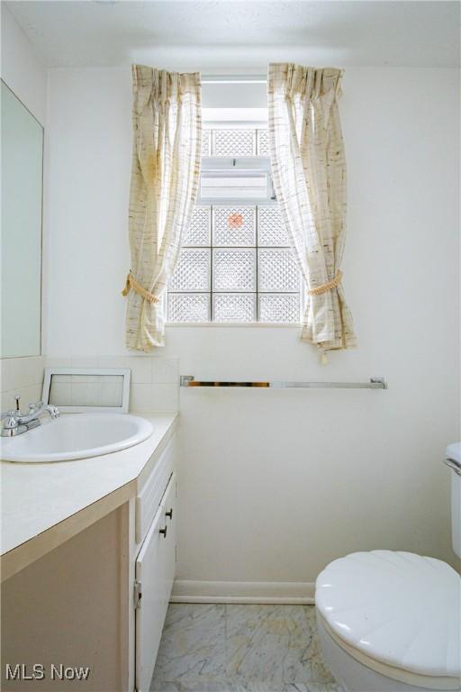 bathroom featuring vanity and toilet