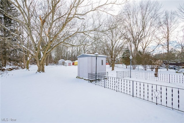 snowy yard with a storage unit