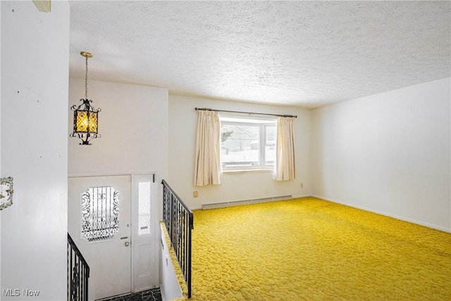 interior space with a textured ceiling, an inviting chandelier, and baseboard heating