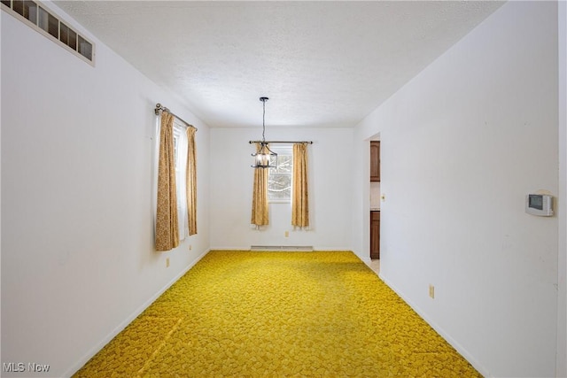 interior space with carpet flooring, a textured ceiling, a chandelier, and a baseboard heating unit