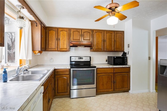 kitchen with tasteful backsplash, custom exhaust hood, stainless steel appliances, ceiling fan, and sink