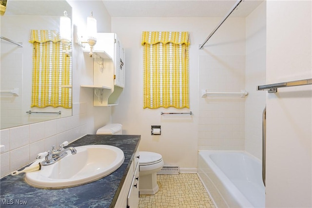 full bathroom with a baseboard radiator, tasteful backsplash, toilet, shower / tub combination, and vanity