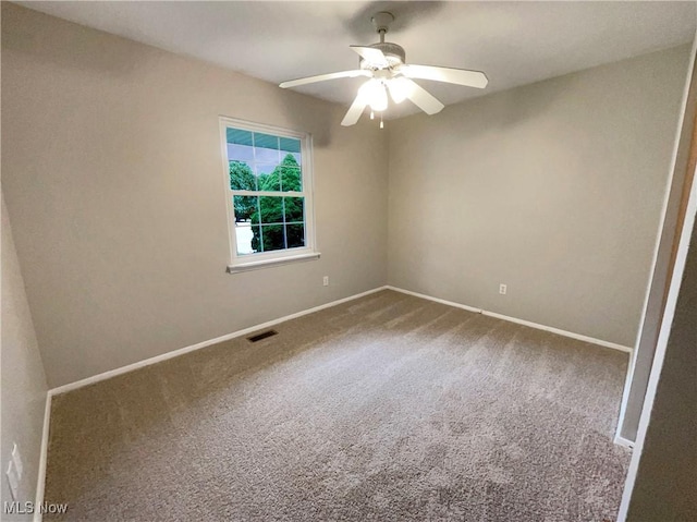 carpeted empty room featuring ceiling fan