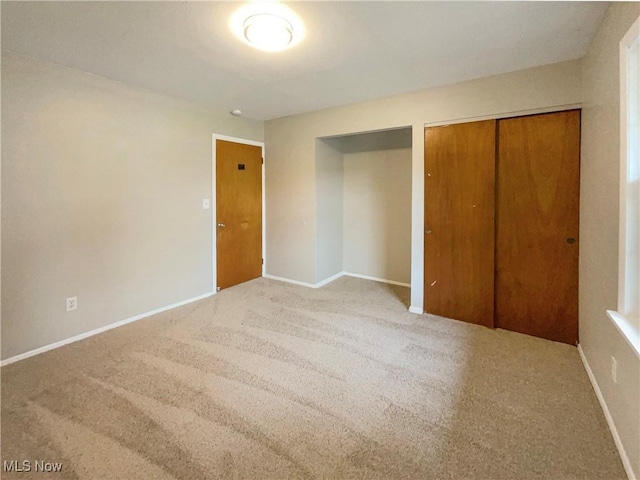 unfurnished bedroom with light carpet