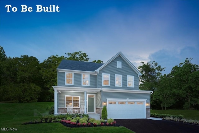 view of front of home with a front yard and a garage